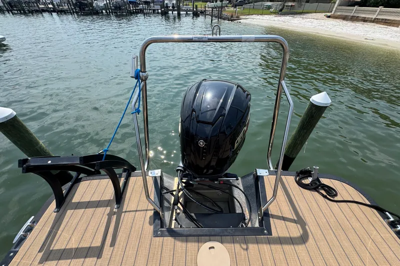 Slide: The Image of 2022 Bennington 23 LXFB boat with outboard motor at dockside. - 24