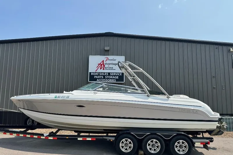 The Image of 2004 Formula 260 Bowrider boat on trailer at marine dealership. - 0