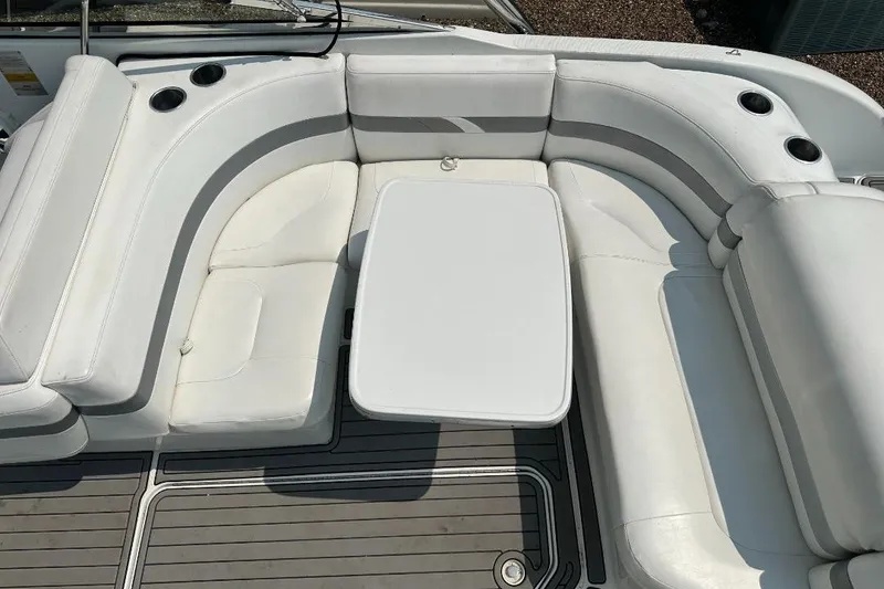 Slide: The Image of 2004 Formula 260 Bowrider interior with white seating and table, featuring cup holders. - 7