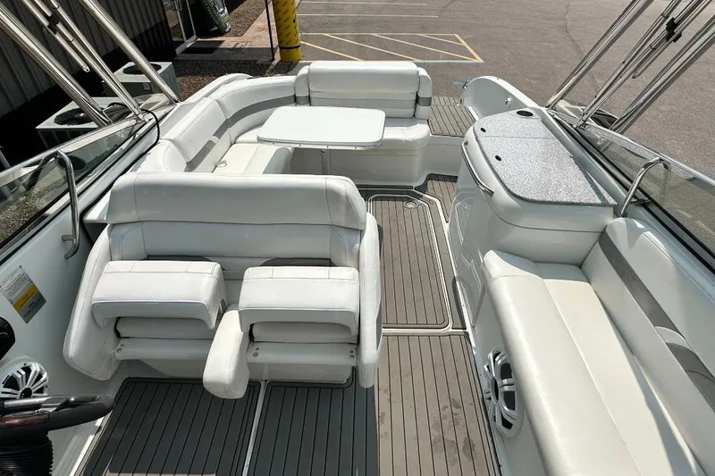 Slide: The Image of Interior of a 2004 Formula 260 Bowrider boat with white seating and table. - 13