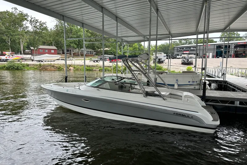 Slide: The Image of 2004 Formula 260 Bowrider boat docked under a covered marina. - 17