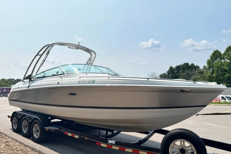 Slide: The Image of 2004 Formula 260 Bowrider boat on trailer under clear sky. - 3
