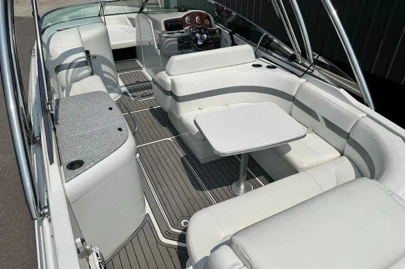 Slide: The Image of 2004 Formula 260 Bowrider interior with white seating and table, showcasing luxury design. - 6