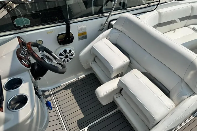 Slide: The Image of 2004 Formula 260 Bowrider interior with white seating and steering wheel. - 11