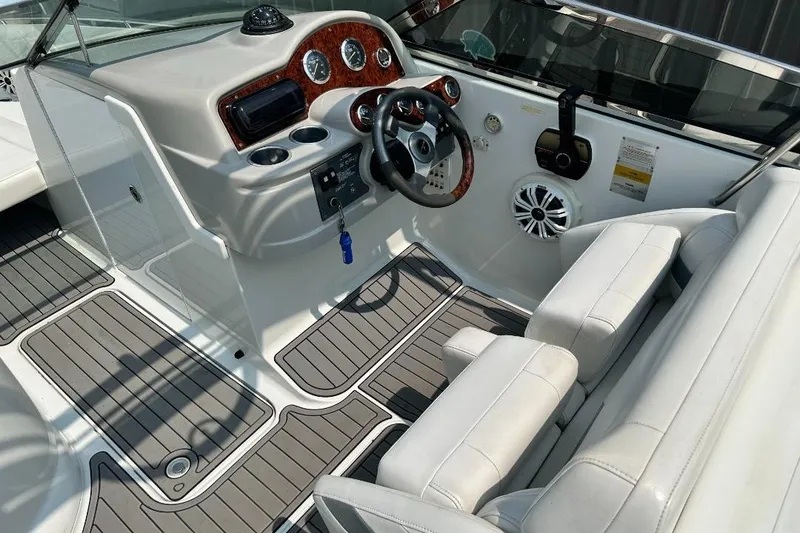 Slide: The Image of 2004 Formula 260 Bowrider cockpit with white seating and modern dashboard controls. - 10