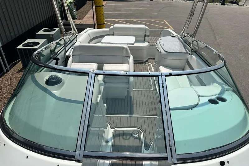 Slide: The Image of 2004 Formula 260 Bowrider boat interior with white seating and glass windshield. - 14