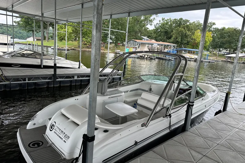 Slide: The Image of 2004 Formula 260 Bowrider docked at a lakeside marina under a covered slip. - 19