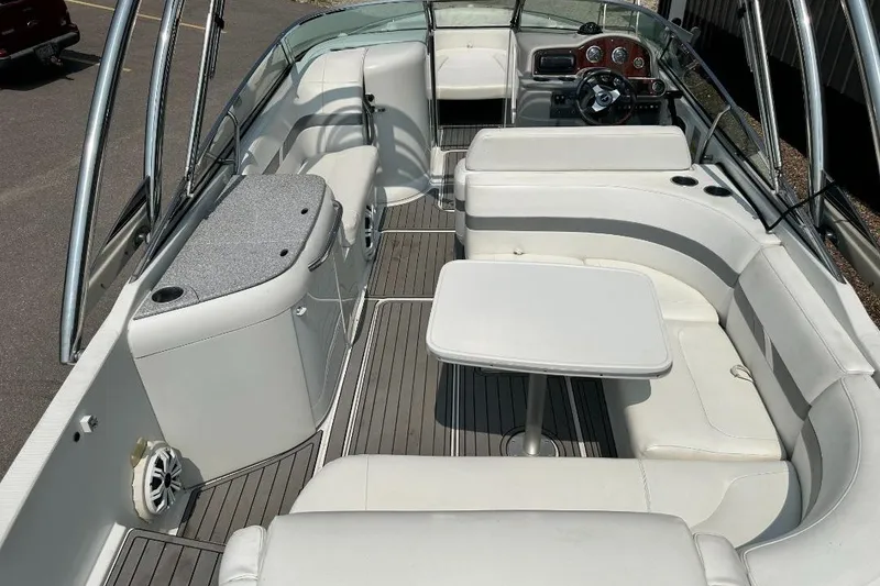 Slide: The Image of 2004 Formula 260 Bowrider interior with white seating, table, and sleek dashboard. - 5