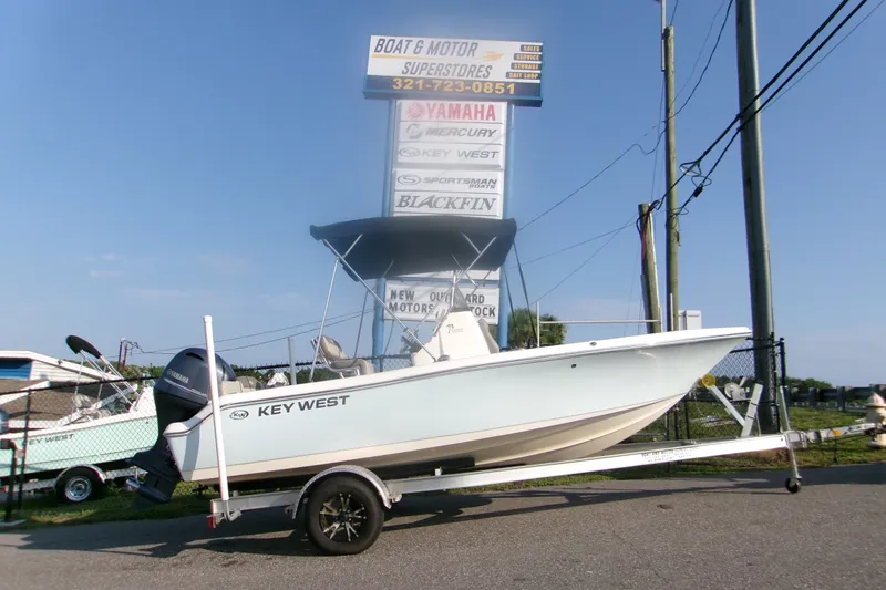 The Image of 2022 Key West 189 FS boat on trailer at dealership, clear sky background. - 1