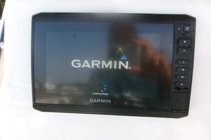 Slide: The Image of Garmin GPS device on 2022 Key West 189 FS boat, displaying loading maps screen. - 17