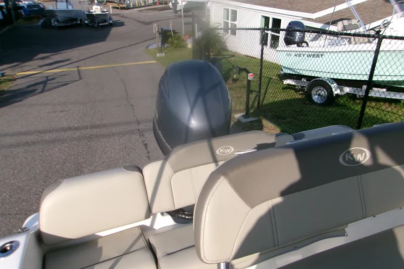 Slide: The Image of 2022 Key West 189 FS boat with outboard motor in a marina setting. - 18