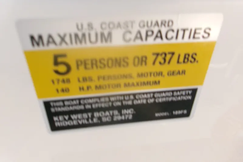 Slide: The Image of 2022 Key West 189 FS boat capacity label: 5 persons or 737 lbs maximum. - 22
