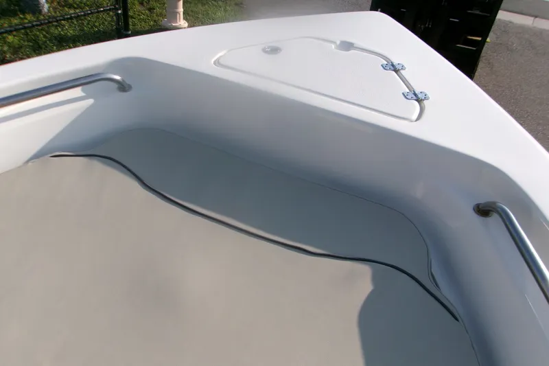 Slide: The Image of 2022 Key West 189 FS boat interior with cushioned seating and storage compartment. - 19