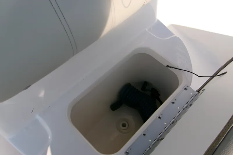 Slide: The Image of Storage compartment in 2022 Key West 189 FS boat, featuring a coiled hose. - 20
