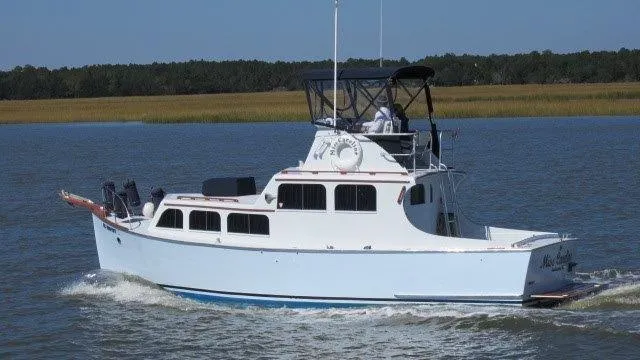 Slide: The Image of 1952 Custom Rose Brothers 32 Flybridge cruising on a calm river. - 1