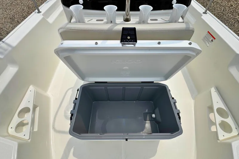 Slide: The Image of Open storage compartment on 2027 Boston Whaler 170 Montauk boat, featuring cup holders. - 16