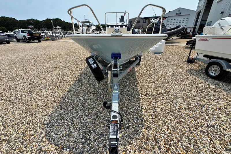 Slide: The Image of 2027 Boston Whaler 170 Montauk boat on trailer in a marina setting. - 19