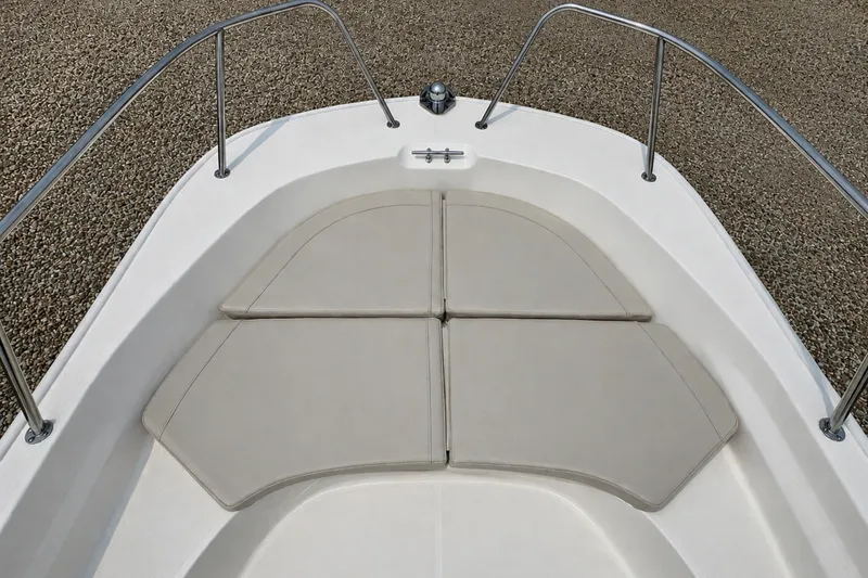 Slide: The Image of 2027 Boston Whaler 170 Montauk bow with cushioned seating and stainless steel railings. - 18