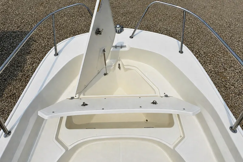 Slide: The Image of 2027 Boston Whaler 170 Montauk boat bow storage compartment open, showcasing spacious design. - 17