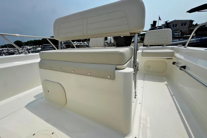 Slide: The Image of 2027 Boston Whaler 170 Montauk boat interior with white seating and storage compartments. - 13