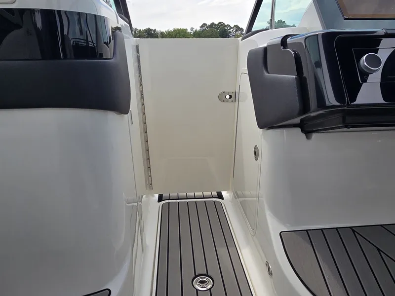 Slide: The Image of The image shows the entryway of a 2025 Sea Ray SLX 260 Surf boat with sleek details. - 24