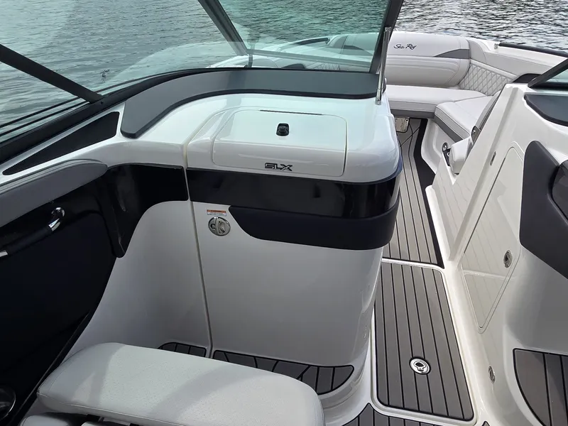 Slide: The Image of The image shows the cockpit of a 2025 Sea Ray SLX 260 Surf boat with sleek seating and modern controls. - 19