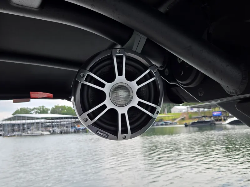Slide: The Image of A speaker is mounted on a boat's structure, with a lake and dock in the background. - 17