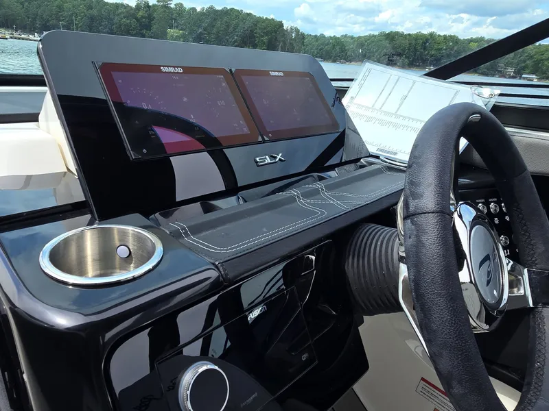 Slide: The Image of The image shows the dashboard of a Sea Ray SLX 260 Surf boat with modern instruments. - 14
