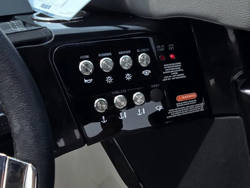 Slide: The Image of Close-up of the control panel with various switches and warning labels. - 15