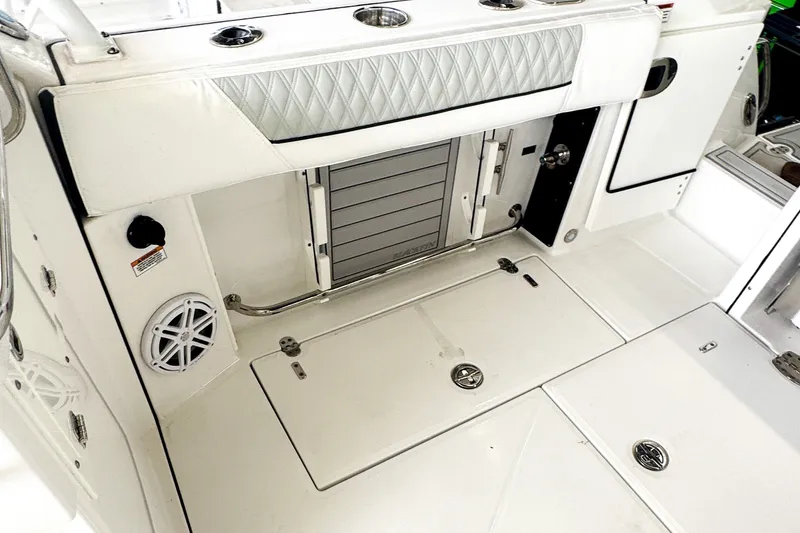 Slide: The Image of 2024 Blackfin 272 DC boat interior with sleek white design and modern amenities. - 5