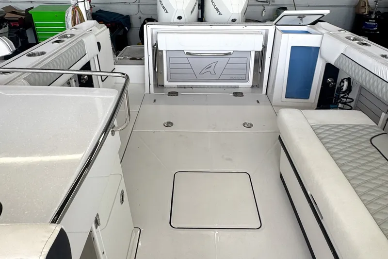 Slide: The Image of 2024 Blackfin 272 DC boat interior with seating and storage compartments. - 1