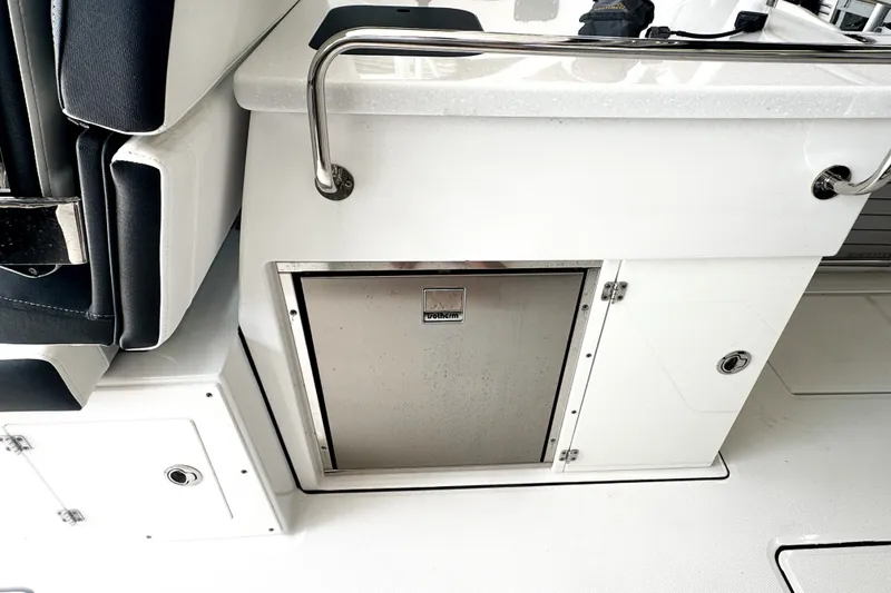 Slide: The Image of 2024 Blackfin 272 DC boat interior with stainless steel storage compartment and seating. - 6