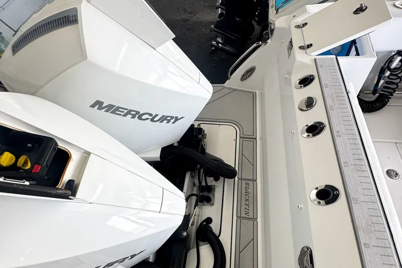 Slide: The Image of 2024 Blackfin 272 DC boat with dual Mercury engines and fishing rod holders. - 11