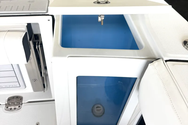 Slide: The Image of 2024 Blackfin 272 DC boat interior with storage compartments and seating. - 7