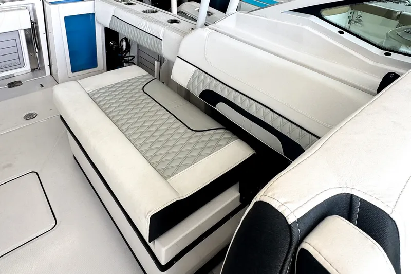 Slide: The Image of 2024 Blackfin 272 DC boat interior with white cushioned seating and modern design. - 4
