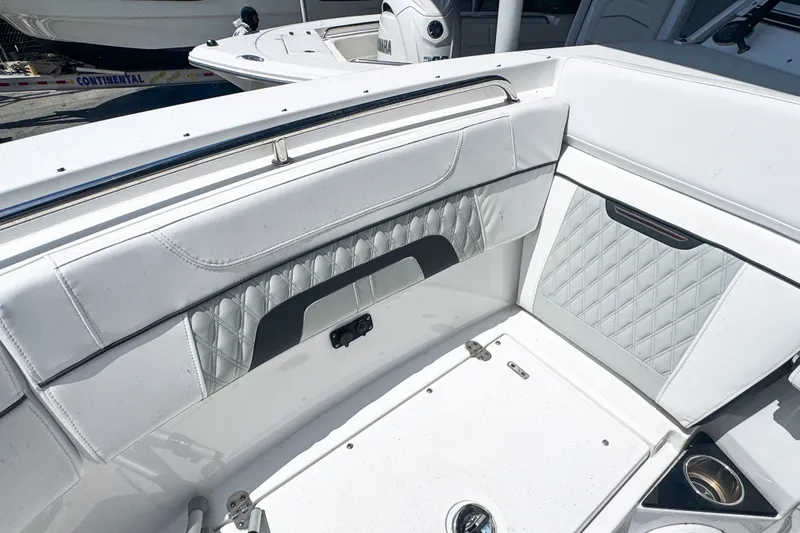 Slide: The Image of 2024 Blackfin 272 DC boat interior with white quilted seating and stainless steel accents. - 10