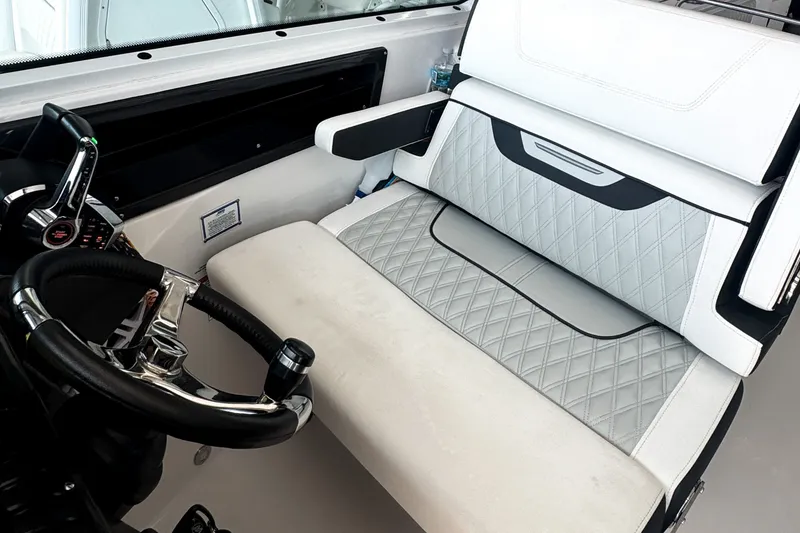 Slide: The Image of 2024 Blackfin 272 DC boat interior with luxurious seating and modern steering controls. - 8