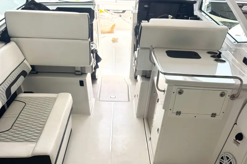 Slide: The Image of 2024 Blackfin 272 DC boat interior with white seating and sleek design. - 2