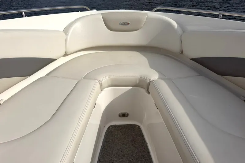 Slide: The Image of 2008 Chaparral 256 SSi boat interior with white cushioned seating and water view. - 46