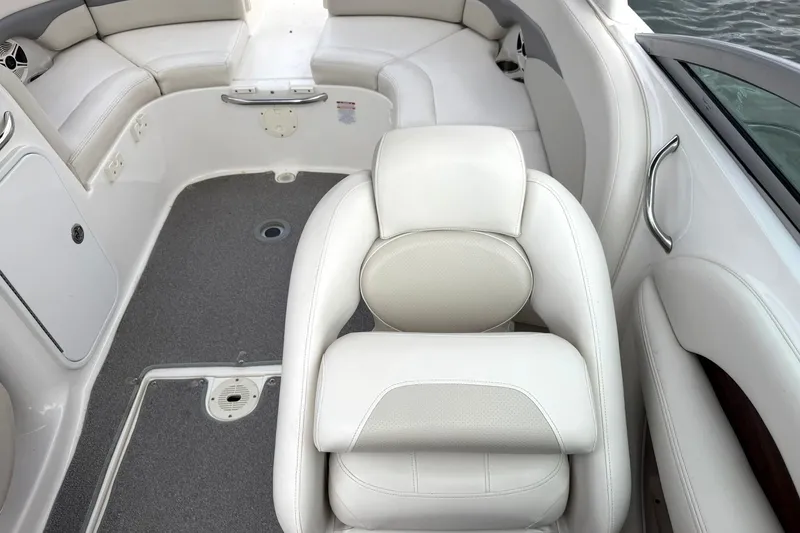 Slide: The Image of 2008 Chaparral 256 SSi boat interior with white seating and gray flooring. - 36