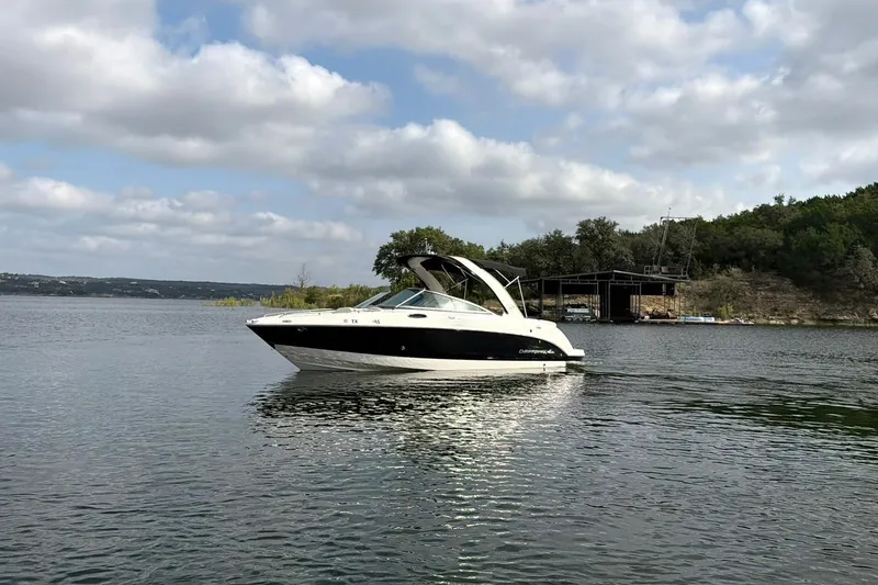 Slide: The Image of 2008 Chaparral 256 SSi boat on a calm lake under a cloudy sky. - 14