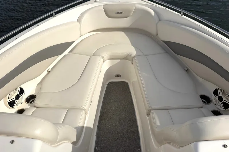 Slide: The Image of 2008 Chaparral 256 SSi boat interior with white cushioned seating and cup holders. - 6