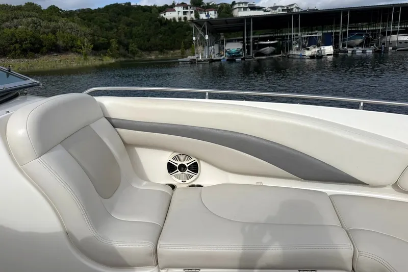 Slide: The Image of 2008 Chaparral 256 SSi boat interior with beige seating and lake view. - 45