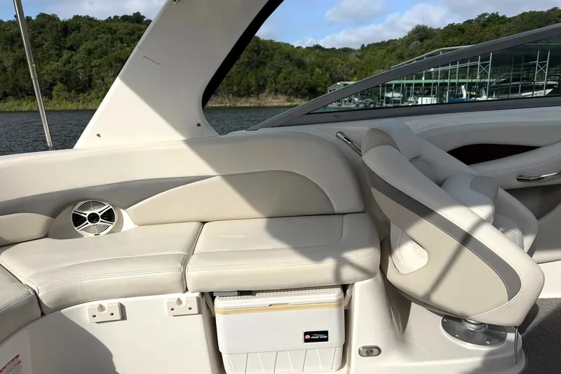 Slide: The Image of 2008 Chaparral 256 SSi boat interior with beige seating and scenic lake view. - 34