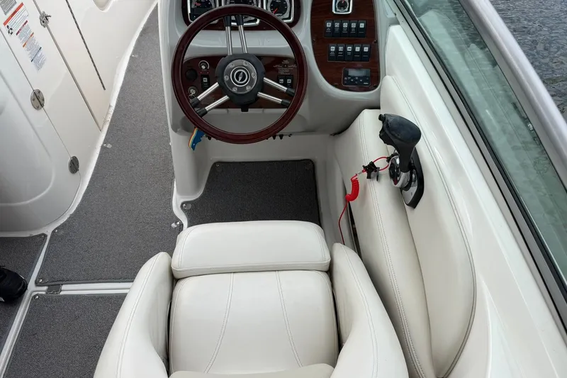 Slide: The Image of 2008 Chaparral 256 SSi boat cockpit with steering wheel and control panel. - 50
