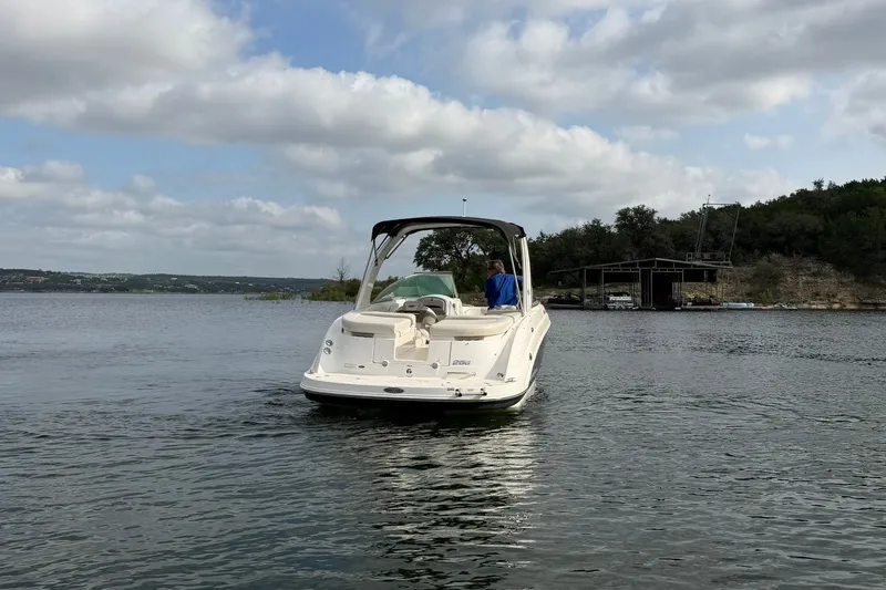 Slide: The Image of 2008 Chaparral 256 SSi boat on a calm lake with cloudy sky backdrop. - 23