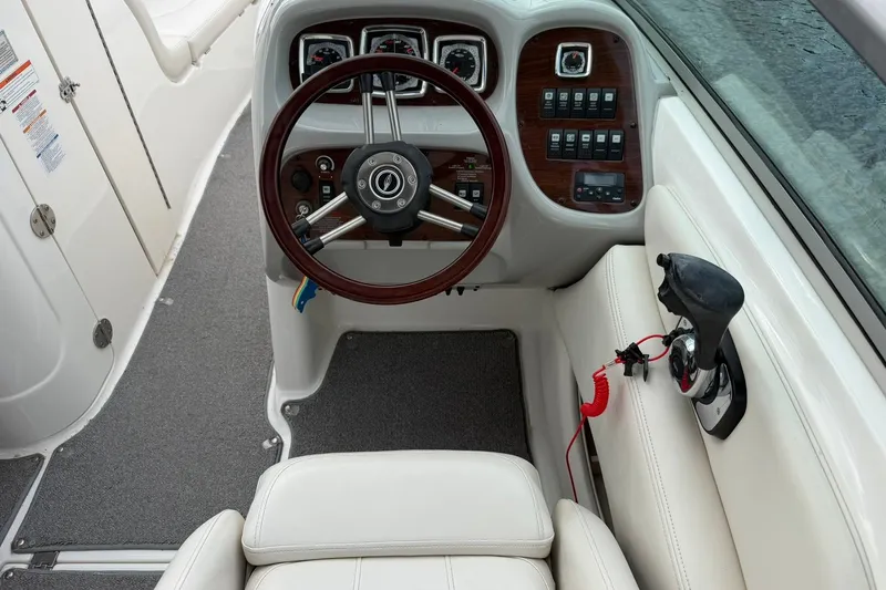 Slide: The Image of 2008 Chaparral 256 SSi boat cockpit with steering wheel and control panel. - 51
