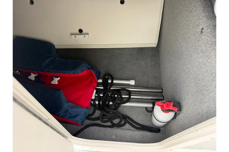 Slide: The Image of Storage compartment of 2008 Chaparral 256 SSi boat with equipment and ropes. - 58