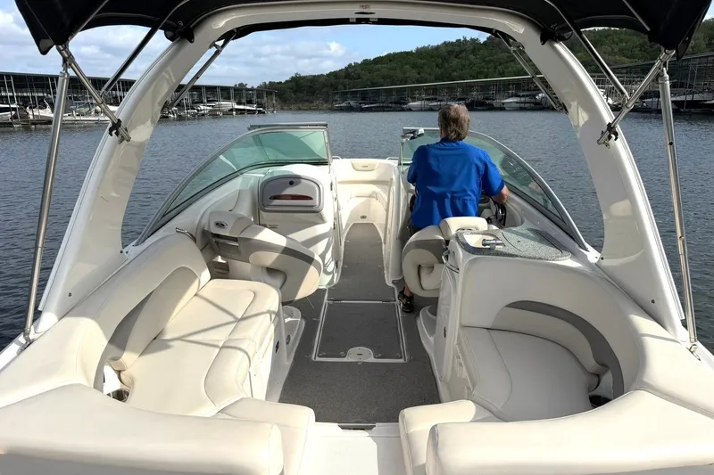 Slide: The Image of 2008 Chaparral 256 SSi boat interior with seating and driver on a lake. - 29