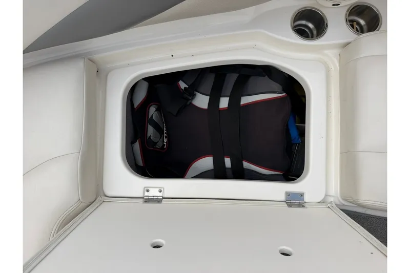Slide: The Image of Storage compartment in a 2008 Chaparral 256 SSi boat with life jacket inside. - 59